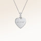 Close-up of minimalist heart-shaped heart pendant in silver with white zircons and space for personalized engraving on the front and back