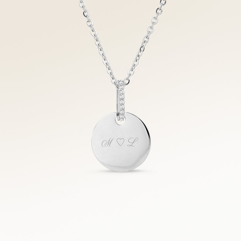 Personalized round silver necklace with white zircons and space for engraving of text, coordinates or handwriting on the front and back