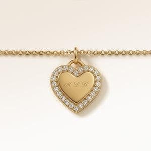 Personalized heart-shaped gold necklace with white zircons along the edge and space for engraving of 8 characters on one line on the front
