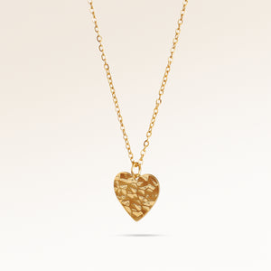 Heart-shaped gold necklace with rippled wave surface side view, space for engraving on back