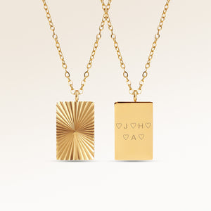 Personalized square gold necklace with ribbed sunburst pattern and space for engraving of text, coordinates or handwriting on the back