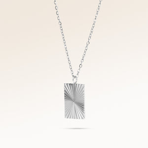 Square silver necklace with ribbed sunburst pattern side view, space for engraving on back