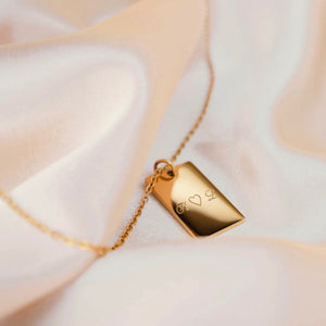 Personalized square gold necklace with space for engraving of text, coordinates or handwriting on the front and back